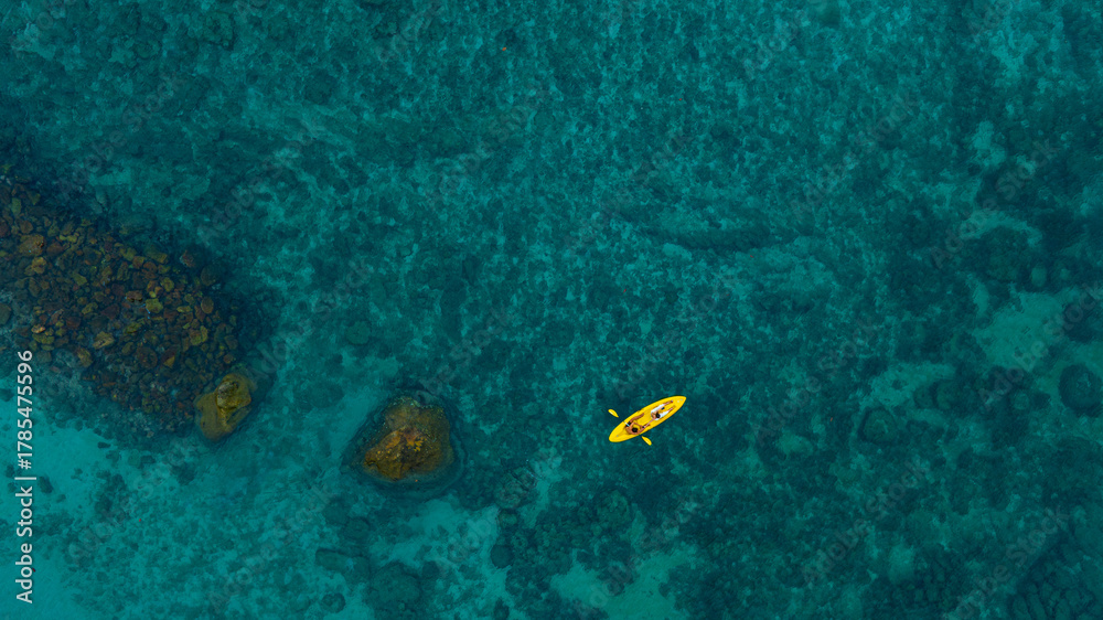 Fototapeta premium Aerial view of a kayak in the blue sea .man kayaking he does water sports activities. 