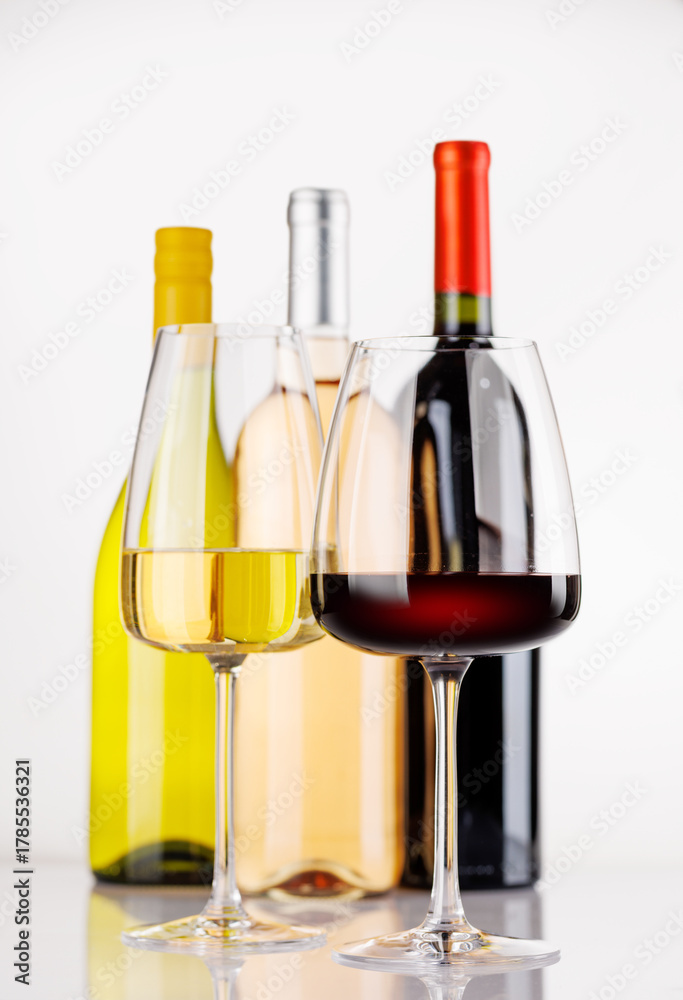Fototapeta premium Different wine bottles and glasses on white background