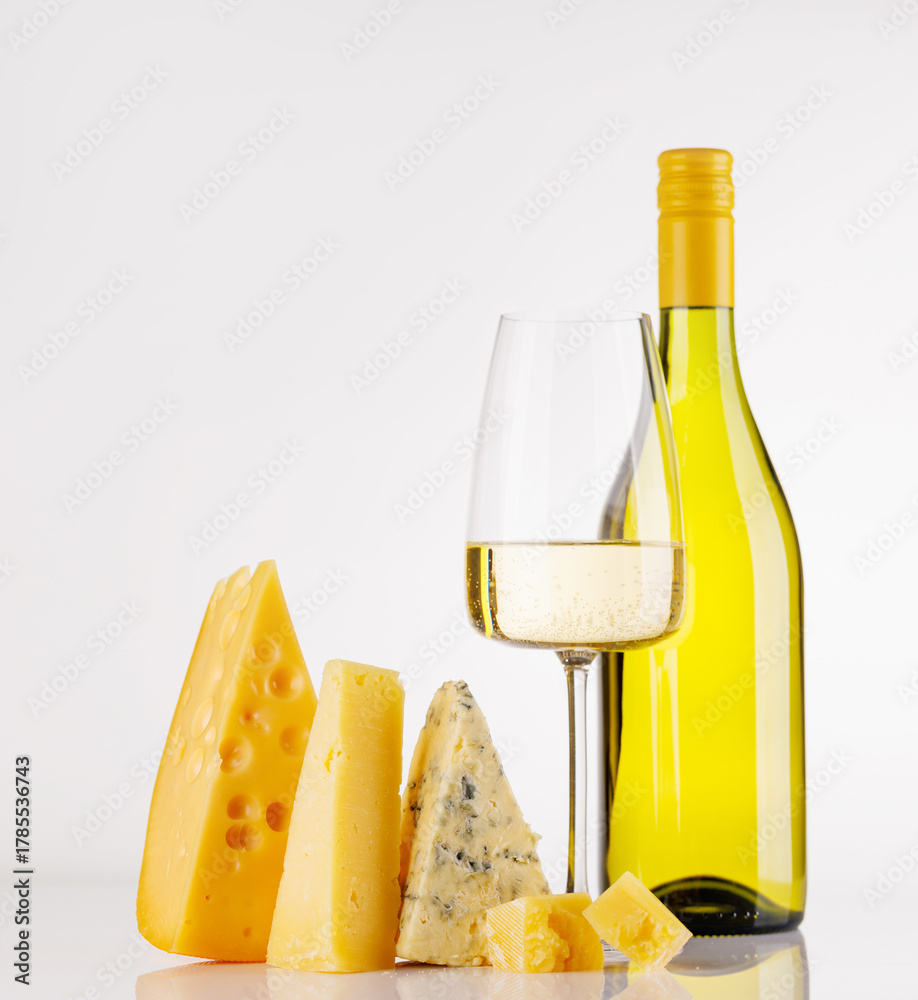 Fototapeta premium Assorted cheeses and wine on white background