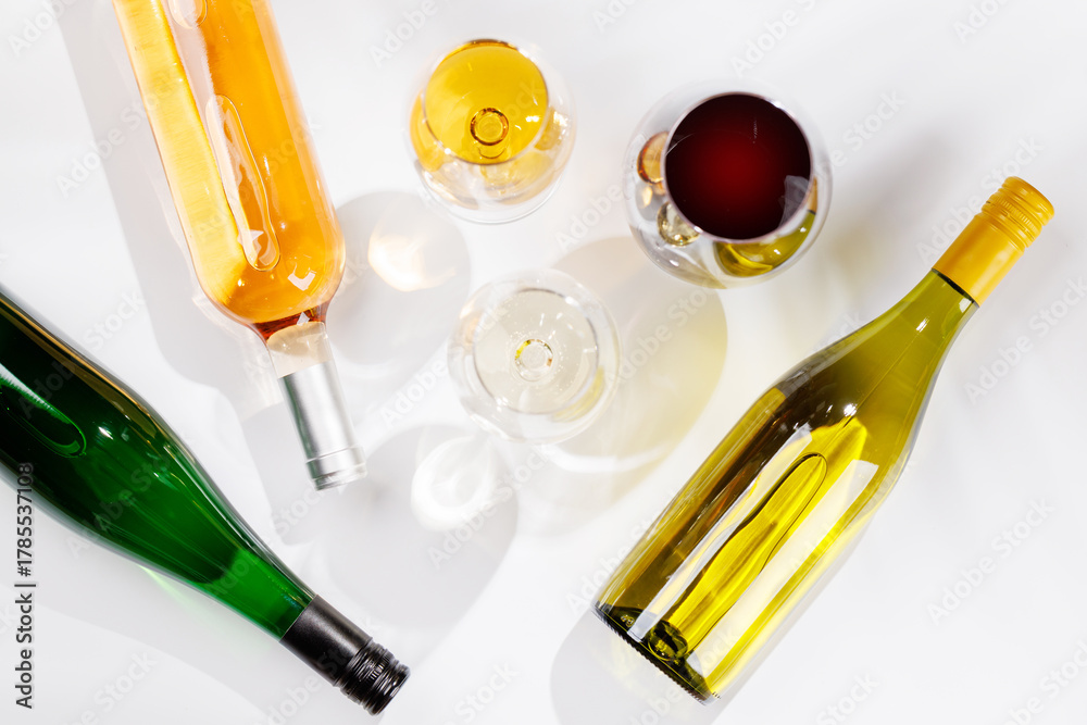Naklejka premium Different wine bottles and glasses on white background
