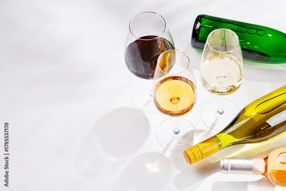 Fototapeta premium Different wine bottles and glasses on white background
