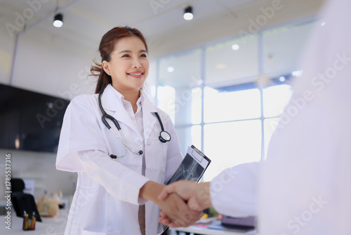female doctor talking to patient standing in hospital, medical professional and healthcare.
