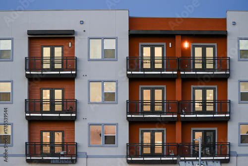 Vászonkép Modern apartment building facade with symmetrical balconies and window units, re