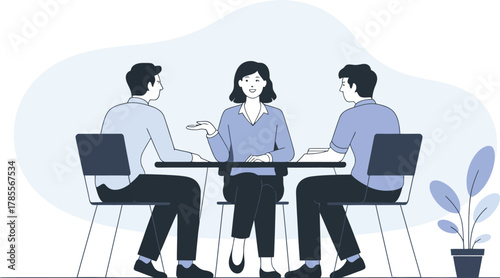 Three people collaborate around a table, discussing ideas in a modern office setting.