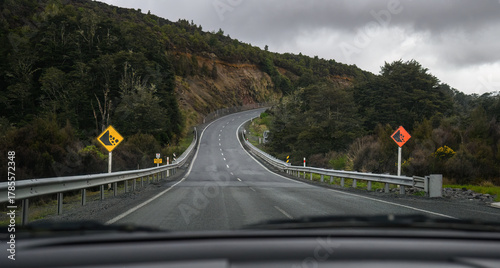 Falling debris sign by the winding mountain road. North Island. New Zealand.