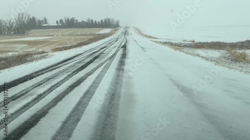 POV, Vehicle driving down a snow covered road during cold winter weather.