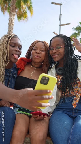 Three young african american friends taking a selfie outdoors