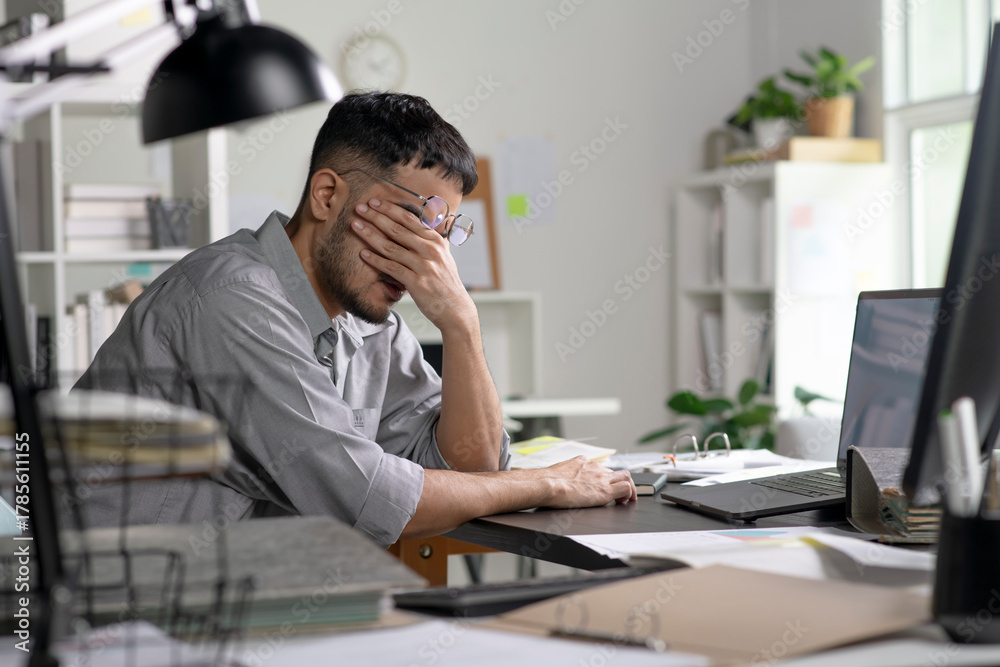 Fototapeta premium Businessman looking stressed from work, Businessman working at office feels overworked and burnout