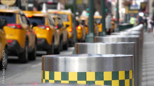 Manhattan Midtown street New York City, United States. Defocused row of yellow taxi cars. Many taxi cabs in line on 8th avenue near Penn Station. Taxi queue, urban road traffic, passenger transport.