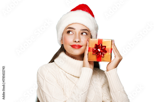 Beautiful woman in a white knitted sweater and santa hat with gift box isolated on transparent background. Christmas or New Year festivities. Holiday and Party