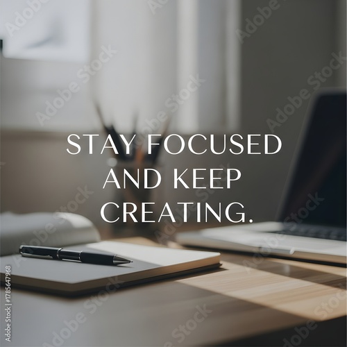 A motivational quote displayed on a modern workspace desk with a laptop, notebook, and pen to inspire productivity and focus during work or study sessions