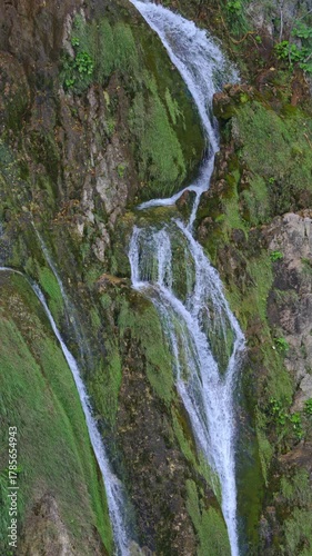 Mountains and waterfalls dreamlike view. The lake mirrors the cascading waterfall. Plitvice waterfalls and lakes. A perfect balance of nature and waterfalls. Waterfalls peaceful landscape.