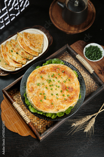 Traditional Chinese Scallion Pancakes with Green Onions on Rustic Wooden Serving Tray