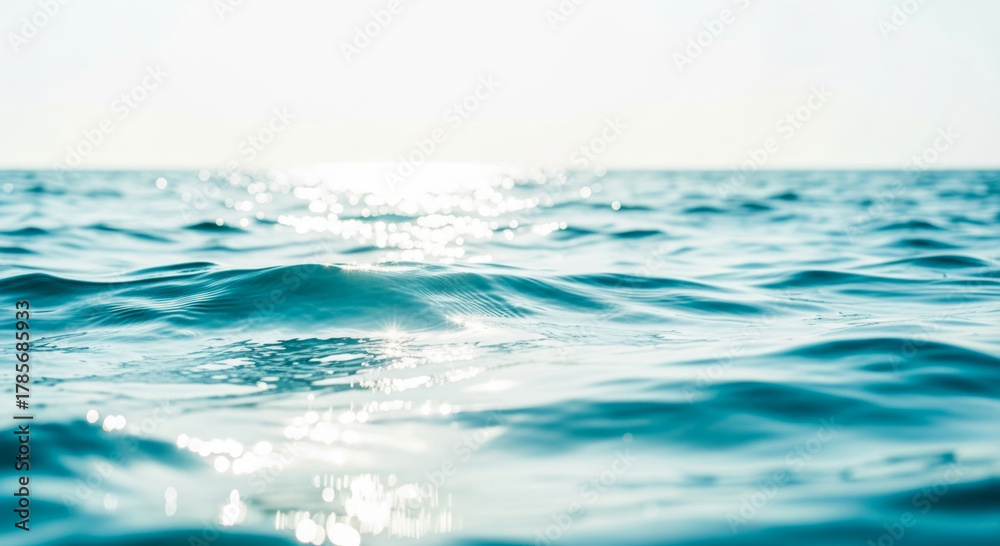 Naklejka premium Calm water ocean sea horizon sunlight ripple blue wave surface reflection bright nature tranquil morning travel environment outdoors liquid peaceful seascape clear coastal summer light movement