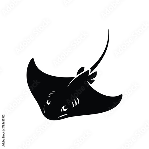 Silhouetted stingray swimming in the ocean depths