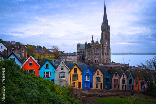 Cobh skyline with the towering Cobh Cathedral and colourful Deck of Cards houses in County Cork, Ireland, a vibrant hilltop cityscape of the historic port once known as Queenstown.