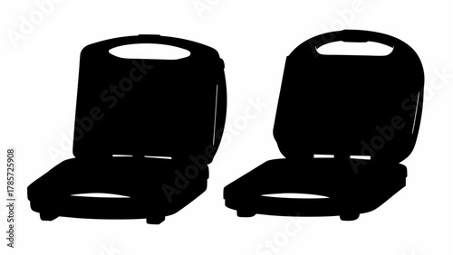 Two black silhouette waffle makers with handles in an open position on a white background image view