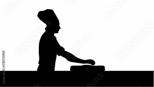 Silhouette of a chef with a tall hat pressing something on a counter in a black and white image style