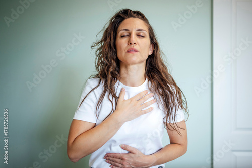 Woman practicing mindfulness and deep breathing for relaxation indoors