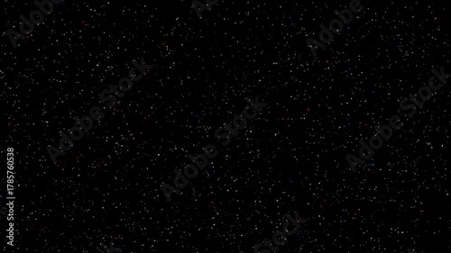 Colorful confetti particles floating on a black background. Multicolored shiny dust.