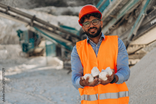 Billede på lærred Successful Middle Eastern Engineer holding white limestone rocks in hands at qua