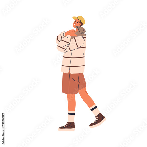 Man carrying rabbit pet. Happy person holding cute bunny in hands, arms. Male...