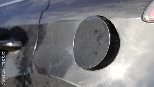 Person opening car fuel cap for refueling