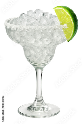Lime wedge perched on the rim of a margarita glass filled with crushed ice and salted edges.