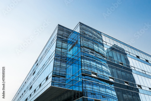 Captivating Modern Architecture with Reflective Glass Facades Against a Clear Blue Sky