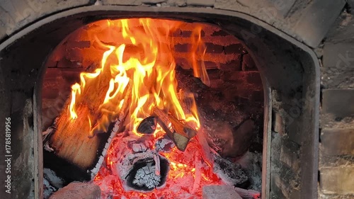 The fire glows warmly inside the brick oven, ready for fresh pizza.