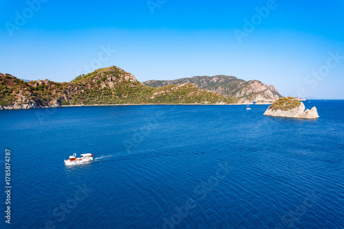 Fototapeta Naklejka Na Ścianę i Meble -  Boat near the Icmeler beach aerial panoramic view, Turkey