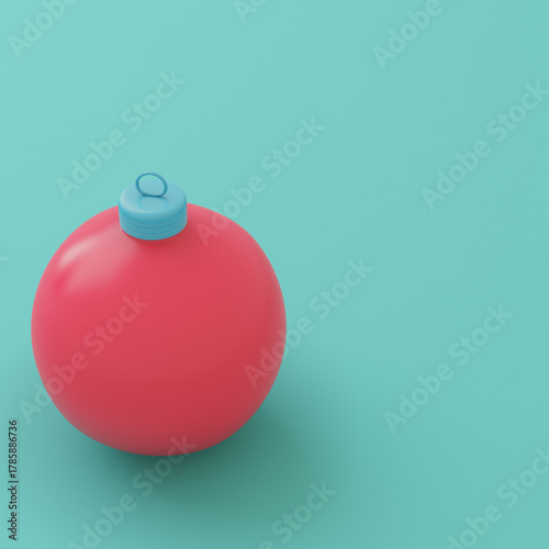 Red christmas bauble on bright turquoise background in pastel colors