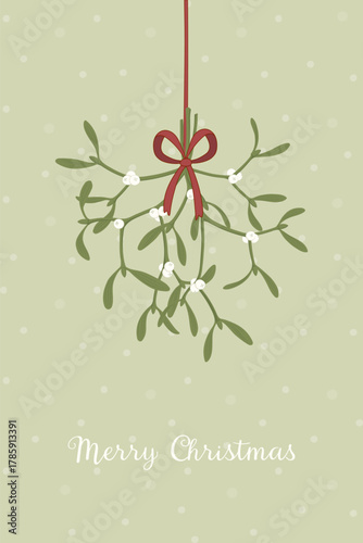Merry Christmas - Schriftzug in englischer Sprache - Frohe Weihnachten. Grußkarte mit einem Mistelzweig und roter Schleife.