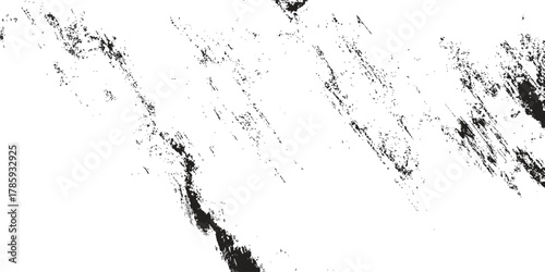 A white backdrop features dark gray and black spots arranged diagonally, creating a distressed or rough textured effect with smudged shapes and a grunge aesthetic adding depth and visual interest