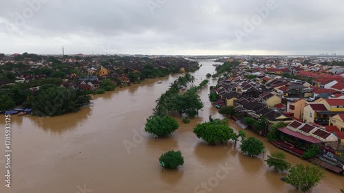 The deepest flood in history in Hoi An, Da Nang 2025. Aerial view of flooded ancient Asian town with yellow houses and brown roofs, showing severe urban flooding and climate disaster impact