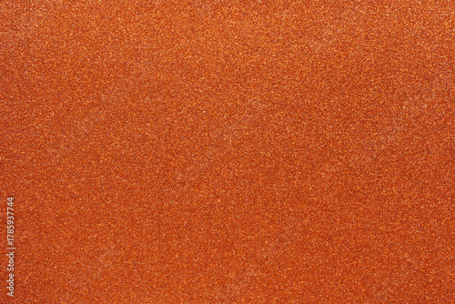Colorful orange glitter background for holiday design textures