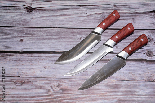 Kitchen knife on a wooden background. Knife with a blade of a wooden handle. Set of different knives