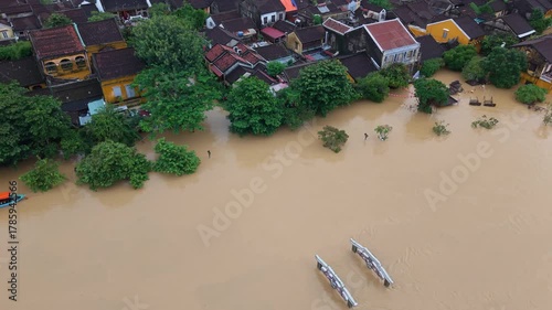 Historic Vietnamese town submerged in muddy floodwater after monsoon rain, showing impact of extreme weather and heritage under threat. Hoi An, Da Nang 2025