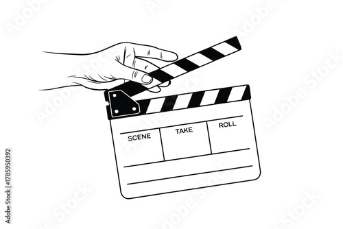 A hand holds a clapperboard in front of a camera to signal the start of a scene.