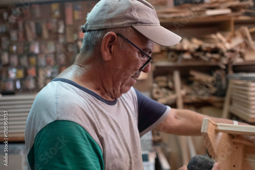 Senior craftsman working with wood in workshop