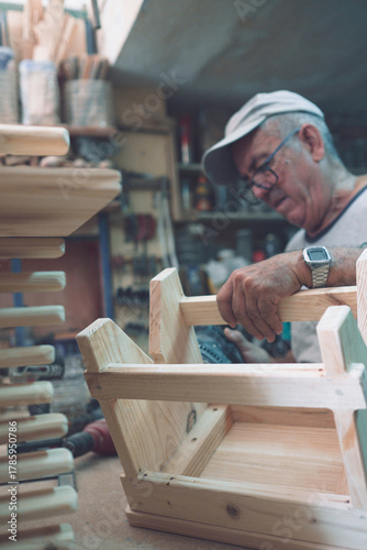 Craftsman assembling wooden furniture in workshop