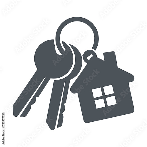 Close up of a house shaped keychain with two keys attached on a silver ring representing home ownership and new beginnings