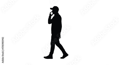 Silhouette of a man wearing a baseball cap walking and talking on a mobile phone against a white background