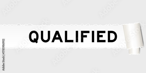 Ripped gray paper background that have word qualified under torn part