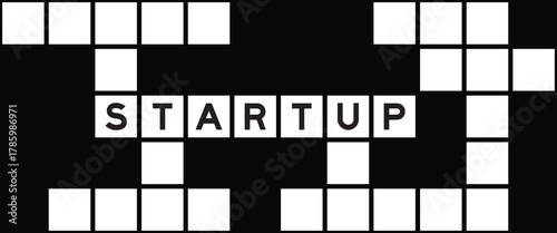 Alphabet letter in word startup on crossword puzzle background