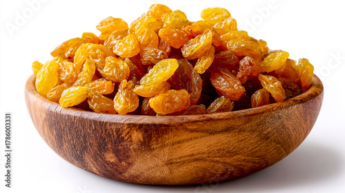 A wooden bowl of golden amber-colored dried raisins on a white background