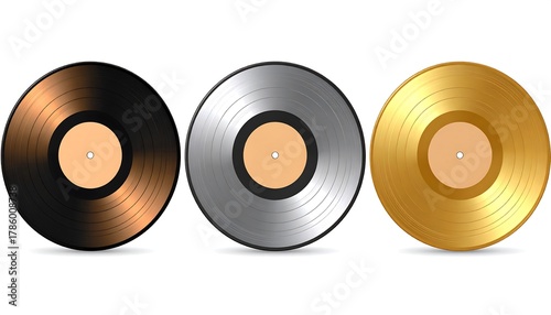 Three stylized circular objects, one black, one silver, and one gold, with tan centers, appear against a clean white background