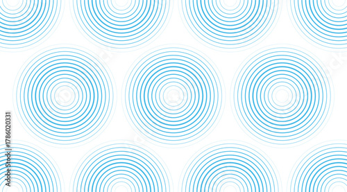 A seamless backdrop features concentric blue circles on a stark white canvas, arranged in a repeating pattern for a rhythmic visual effect with calming and modern aesthetic