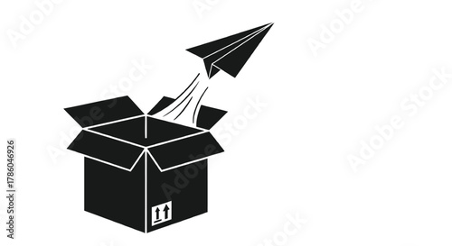 Black paper airplane launching from an open cardboard box symbolizing innovation and escape from the ordinary