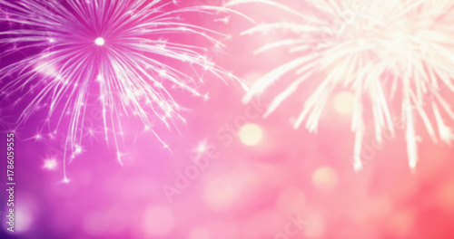 Bright fireworks on abstract defocused pink background